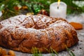 Traditional Christmas cake with dried fruits, raisins and nuts with Christmas decorations on wooden background Royalty Free Stock Photo