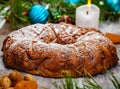 Traditional Christmas cake with dried fruits, raisins and nuts with Christmas decorations on wooden background. Royalty Free Stock Photo