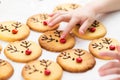 Child decorates homemade reindeer cookies