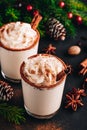 Traditional Christmas drink Eggnog with whipped cream and cinnamon on dark stone background Royalty Free Stock Photo