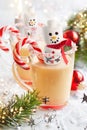 Traditional Christmas Eggnog with sweet treat snowman marshmallow and candy cane peppermint