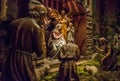 Traditional Christmas nativity scene with beautiful figures made out of wood. The birth of Jesus Christ in the manger surrounded Royalty Free Stock Photo