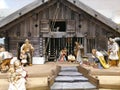 Traditional Christmas nativity scene with beautiful figures made out of wood. The birth of Jesus Christ in the manger surrounded Royalty Free Stock Photo
