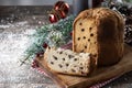 Traditional Christmas panettone with red tie and christmas ornaments on wooden table