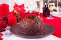 Traditional Christmas pudding with holly on top. Royalty Free Stock Photo