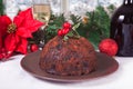 Traditional Christmas pudding with holly on top on the wooden background Royalty Free Stock Photo