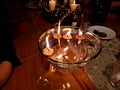 a traditional Christmas table with a metal tree and candles