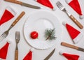 Traditional Christmas table place setting with empty white plate, linen napkin, cutlery with festive decorations Royalty Free Stock Photo
