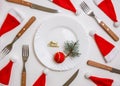 Traditional Christmas table place setting with empty white plate, linen napkin, cutlery with festive decorations Royalty Free Stock Photo