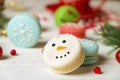 Traditional christmas themed french macaroons sweets in the form of snowman, snowflake, christmas tree and santa`s belly with can Royalty Free Stock Photo