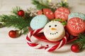 Traditional christmas themed french macaroons sweets in the form of snowman, snowflake, christmas tree and santa`s belly with can