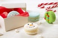 Traditional christmas themed french macaroons sweets in the form of snowman, snowflake, christmas tree and santa`s belly with can Royalty Free Stock Photo