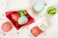 Traditional christmas themed french macaroons sweets in the form of snowman, snowflake, christmas tree and santa`s belly with can Royalty Free Stock Photo