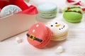 Traditional christmas themed french macaroons sweets in the form of snowman, snowflake, christmas tree and santa`s belly with can Royalty Free Stock Photo