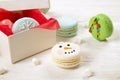 Traditional christmas themed french macaroons sweets in the form of snowman, snowflake, christmas tree and santa`s belly with can Royalty Free Stock Photo