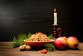 Traditional Christmas treat of the Slavs on Christmas eve kutia. Fir branch, apples, candle on wooden background Royalty Free Stock Photo