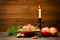 Traditional Christmas treat of the Slavs on Christmas eve kutia. Fir branch, apples, candle on wooden background Royalty Free Stock Photo