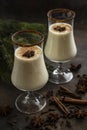 Traditional Christmas winter drink eggnog with cinnamon  in glasses Royalty Free Stock Photo