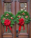 Christmas wreath with pine and red ribbon on double door Royalty Free Stock Photo