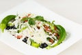 Traditional classic Shopska salad with tomatoes, peppers, cucumbers and cheese in white dish on white wooden table. Bulgarian cuis Royalty Free Stock Photo