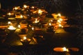 Traditional clay diya lamps lit during diwali celebration, fireworks in the background Happy Diwali - Lit diya lamp on street at Royalty Free Stock Photo