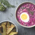 Traditional cold Lithuanian borscht or Saltibarscai with baked potatoes. Kefir summer diet meals for hot weather Royalty Free Stock Photo