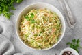 Traditional cole slaw salad in a bowl on a gray concrete background. Salad with cabbage, carrot and mayonnaise sauce. Royalty Free Stock Photo