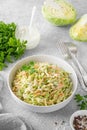 Traditional cole slaw salad in a bowl on a gray concrete background. Salad with cabbage, carrot and mayonnaise sauce. Royalty Free Stock Photo