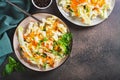 Traditional cole slaw salad of cabbage, carrots and greens on a plate top view Royalty Free Stock Photo