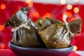 Traditional Colombian tamale as made on Tolima region over a christmas red background