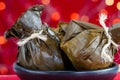Traditional Colombian tamale as made on Tolima region over a christmas red background