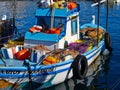 Traditional colorful Cypriot fishing boat in clear blue water Paphos Cyprus