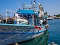 Traditional colorful Cypriot fishing boat in clear blue water Paphos Cyprus