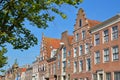 Traditional and colorful facades located along Spaarne river, with the Teylers Museum on the left