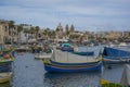 Traditional colorful fishing boats in the harbor of fishing village Marsaxlokk, Malta