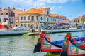 Traditional colorful Moliceiro boat mooring in water canal in Aveiro city historical centre