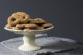 Traditional cookie from The Netherlands called Krakeling, on white cake stand. Grey background and space for text Royalty Free Stock Photo