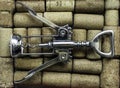 Traditional corkscrew with metallic arms on cork stopper collection