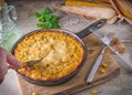 Traditional corn casserole with cheese. Below the corn - parsley mix is ground cheese, olive, egg, baked onion, garlic Royalty Free Stock Photo