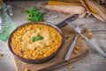 Traditional corn casserole with cheese. Below the corn - parsley mix is ground cheese, olive, egg, baked onion, garlic Royalty Free Stock Photo