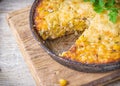 Traditional corn casserole with cheese. Below the corn - parsley mix is ground cheese, olive, egg, baked onion, garlic