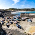 Traditional Cornish fishing boats moored in Coverack harbour with the tide out