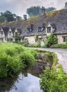 Traditional cotswold stone cottages built of distinctive yellow limestone in the famous Arlington Row, Bibury Gloucestershire UK Royalty Free Stock Photo