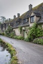 Traditional cotswold stone cottages built of distinctive yellow limestone in the famous Arlington Row, Bibury Gloucestershire UK Royalty Free Stock Photo