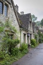 Traditional cotswold stone cottages built of distinctive yellow limestone in the famous Arlington Row, Bibury Gloucestershire UK Royalty Free Stock Photo