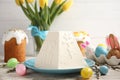 Traditional cottage cheese Easter paskha and dyed eggs on white wooden table Royalty Free Stock Photo