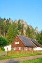 Traditional cottage with forest and sandstone towers