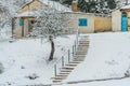 Traditional Cottage in a Snow Covered Village in a Greek Mountain During Snowfall on Winter Seasons Royalty Free Stock Photo