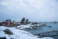 Traditional cottages on the islands around Oslo Norway during the winter overlooking the sea and the Fjord in snow condition Royalty Free Stock Photo