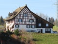 Traditional country houses and old livestock farms along the Bergweiher pond and on the slopes of the Horgenberg hill, Horgen Royalty Free Stock Photo